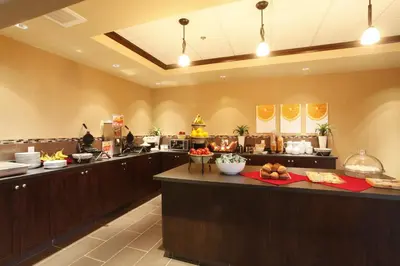 a buffet line in a restaurant with food at Vegreville Suites in Vegreville