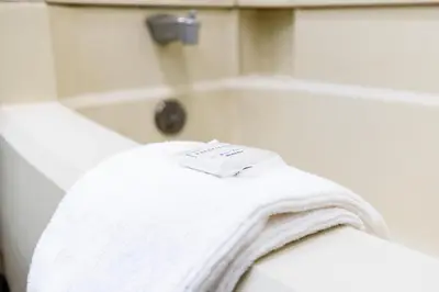 a white towel sitting on the edge of a bath tub at SureStay by Best Western Smithers in Smithers