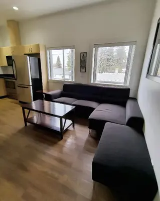 a living room with a couch and a table at Fireweed Motel in Smithers