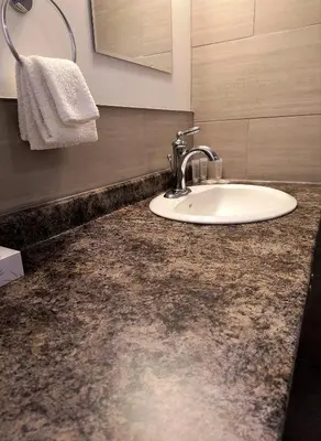 a bathroom with a sink and a counter top at Fireweed Motel in Smithers