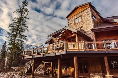 a log home with a wrap around deck at Winston Lodge in Golden