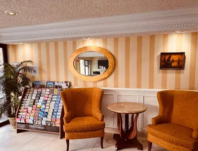 a store with two chairs and a table and a mirror at Island Travel Inn in Victoria