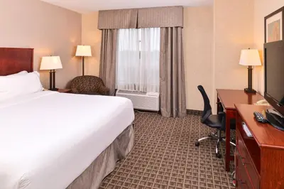 a hotel room with a bed and a desk with a computer at Holiday Inn Express Edmonton North by IHG in Edmonton