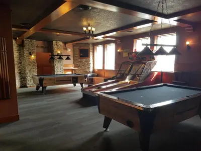 a billiard room with a pool table and a pool table at Twin Pine Inn & Suites in Hinton