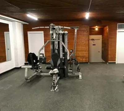 a room with a gym with a tread machine at Crestwood Hotel in Hinton