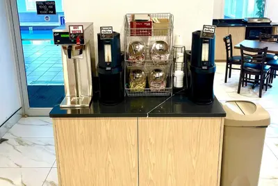 a counter with two coffee machines on top of it at Super 8 by Wyndham Hinton-Free Breakfast,Wifi,Parking in Hinton