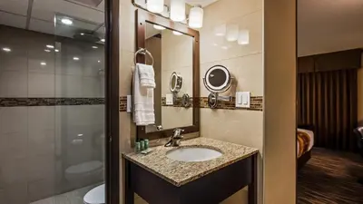 a bathroom with a sink and a shower at Best Western Wayside Inn in Wetaskiwin