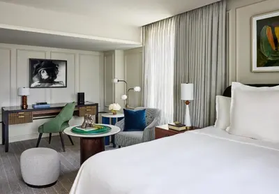 a hotel room with a bed and a desk at Rosewood Hotel Georgia in Vancouver
