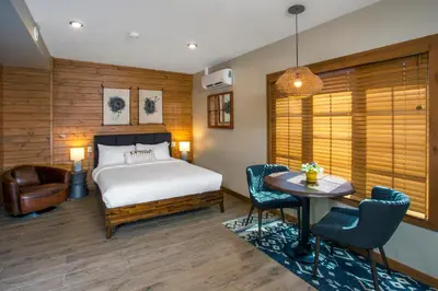 a bedroom with a bed and a table and chairs at Bear Hill Lodge in Jasper