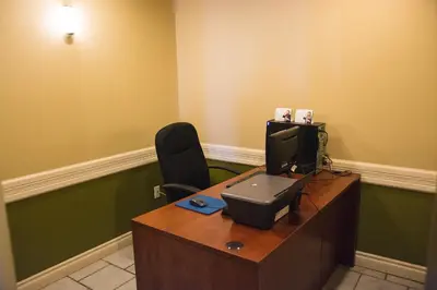 a office with a desk with a computer and a chair at Days Inn by Wyndham High Level in High Level