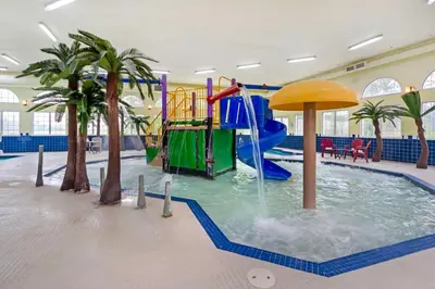 a water park with a water slide in a pool at Best Western PLUS Mirage Hotel and Resort in High Level