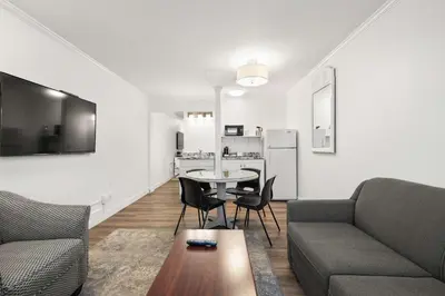 a living room with a couch and a table at SureStay Hotel by Best Western Rossland Red Mountain in Rossland
