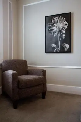 a room with a chair and a picture on the wall at Regent Hotel Revelstoke in Revelstoke