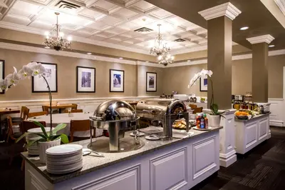 a restaurant with a counter with dishes on it at Regent Hotel Revelstoke in Revelstoke
