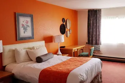 a hotel room with a bed and a window at Howard Johnson by Wyndham Fort St. John in Fort Saint John