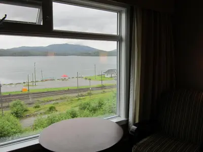 a window with a table and a view of the water at Inn on the Harbour in Prince Rupert