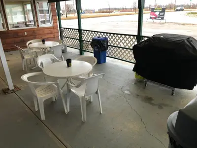 a row of tables and chairs on a porch at Airways Motel in Cold Lake