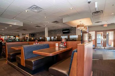 a fast food restaurant with a table and chairs at Sandman Hotel Penticton in Penticton