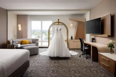 a wedding dress hanging in a hotel room at Courtyard by Marriott Prince George in Prince George