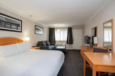 a hotel room with a bed and a desk at Sandman Hotel Revelstoke in Revelstoke