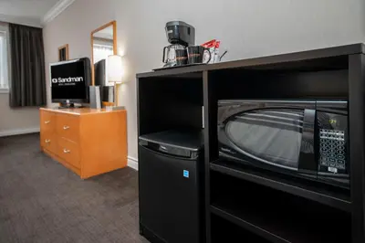 a microwave sitting on a shelf in a hotel room at Sandman Hotel Revelstoke in Revelstoke