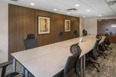 a conference room with a long table and chairs at Best Western Dawson Creek in Dawson Creek