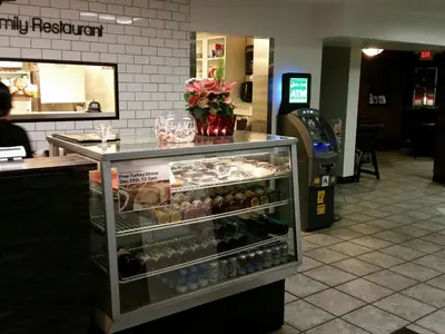 a display case in a restaurant with wine bottles at Wild Rose Country Inn in Grande Prairie