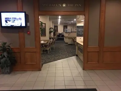 a door to a restaurant with a waiting room at St. Albert Inn & Suites in St. Albert