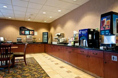 a fast food restaurant with a counter and a coffee shop at Days Inn & Suites by Wyndham Strathmore in Strathmore
