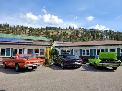 a group of cars parked in a parking lot at Lido Motel in Radium Hot Springs