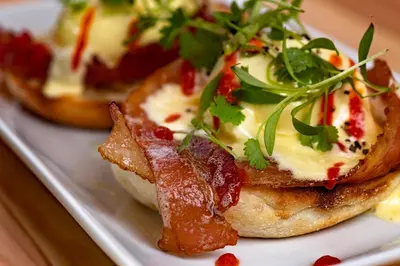 a plate of appetizers with bacon and cheese at Pangea Pod Hotel in Whistler