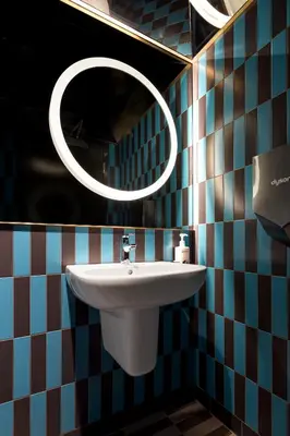 a bathroom with a sink and a mirror at Pangea Pod Hotel in Whistler