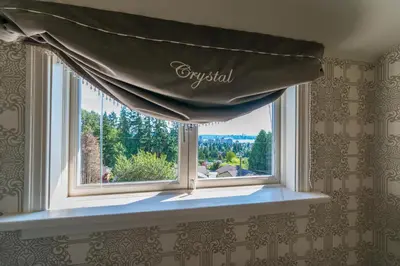 a window with a curtain in a room at Crystal's View Bed & Breakfast in North Vancouver