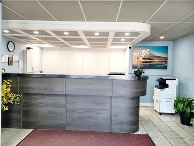 an office lobby with a counter with a counter top at Canadian Motor Inn in Grande Prairie