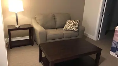 a living room with a couch and a table at Northwood Plaza Hotel in Prince George