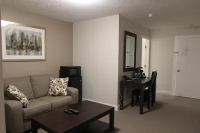 a living room with a couch and a table at Northwood Plaza Hotel in Prince George