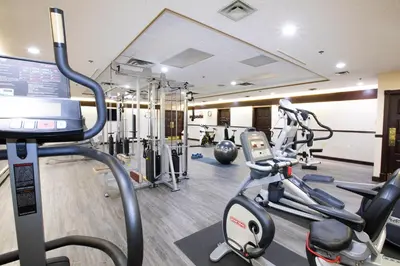 a gym with cardio equipment in a hotel room at Tower Inn & Suites in Quesnel