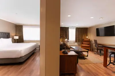 a hotel room with a bed and a desk at Prestige Hudson Bay Lodge & Conference Centre, WorldHotels Crafted Collection in Smithers
