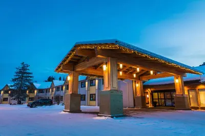 a building with a pavilion with lights in the snow at Prestige Hudson Bay Lodge & Conference Centre, WorldHotels Crafted Collection in Smithers
