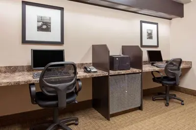 an office with two desks with computers and two chairs at Ramada by Wyndham Brooks in Brooks