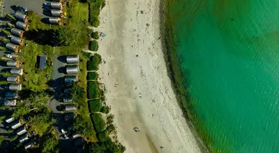 an overhead view of a beach and the ocean at Ocean Village Resort in Tofino