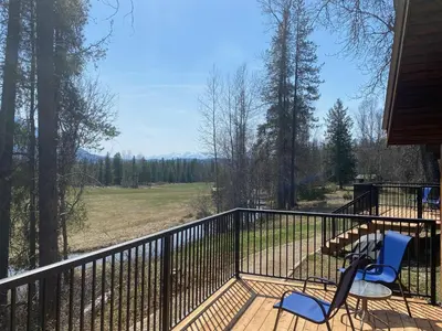 a balcony with two chairs and a table on a porch at Rocky Mountain Cabins and Home in Golden