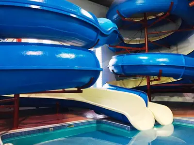 a slide in a water park with a pool at Travelodge by Wyndham Lloydminster in Lloydminster