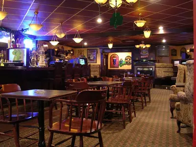 a restaurant with tables and chairs and a bar at Travelodge by Wyndham Lloydminster in Lloydminster