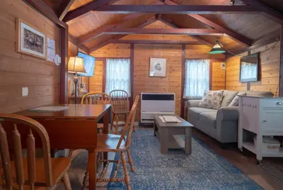 a living room with a table and a couch at Hillside Bungalows in Banff