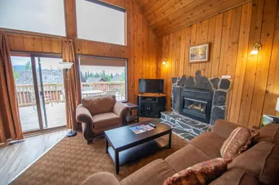 a living room with a couch and a fireplace at Banff Gate Mountain Resort in Canmore