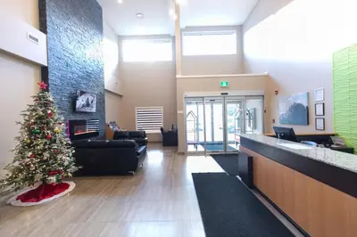 a christmas tree in the lobby of a hospital at Super 8 by Wyndham Canmore in Canmore