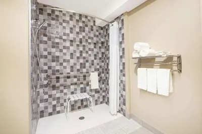 a bathroom with a shower with a glass door at Super 8 by Wyndham Canmore in Canmore