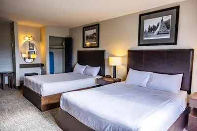 a hotel room with two beds and two lamps at Stoney Nakoda Resort & Casino in Seebe