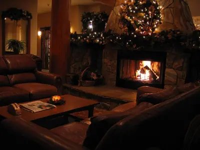 a living room with a fireplace with couches and a fire place at Snow Creek Lodge by Fernie Lodging Co in Fernie